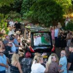 Huge crowds applaud, sing and hold out for a heroine as Bonnie Tyler's coffin returns home