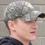 Connor Storrie’s Camo Hat Can’t Hide His Buzz Cut