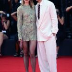 Suki Waterhouse puts on a leggy display in a chic £5k Saint Laurent lace minidress as she joins her fiancé Robert Pattinson at the Primetime premiere during the Venice International Festival