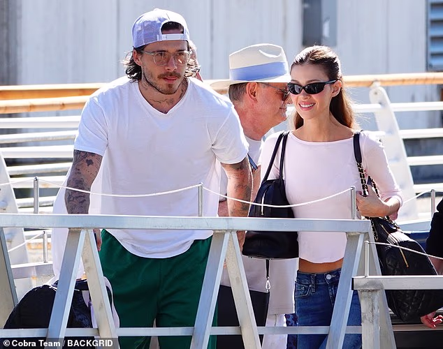 Brooklyn Beckham and wife Nicola Peltz beam as they make low-key departure from Venice Film Festival after loved-up red carpet appearance