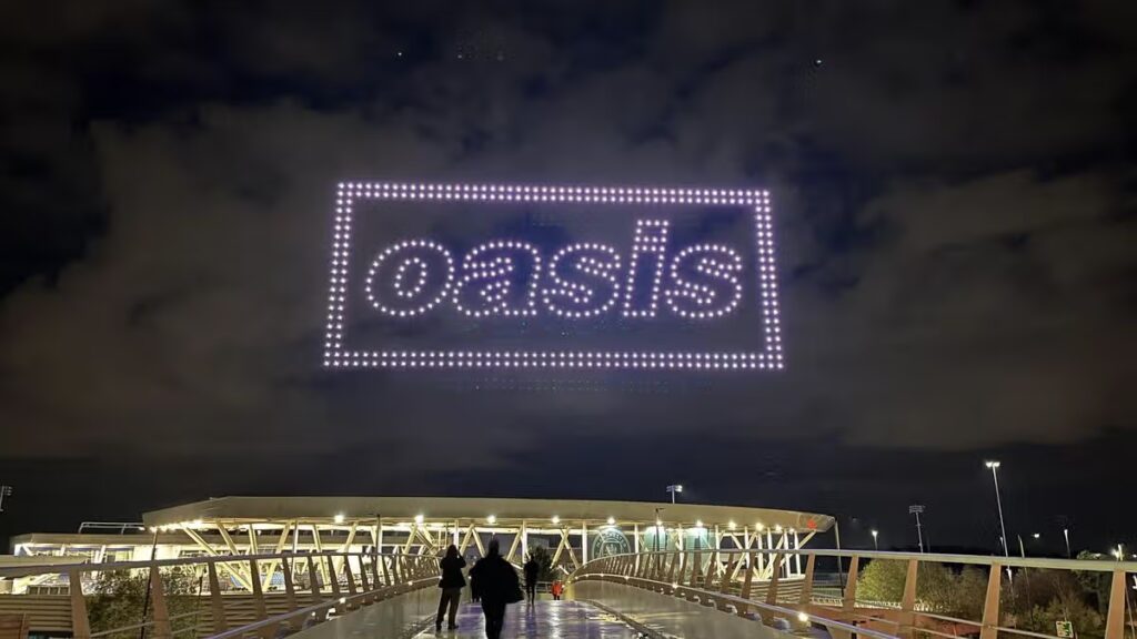 Oasis confirm 2027 tour announcement – with spectacular light display over Manchester