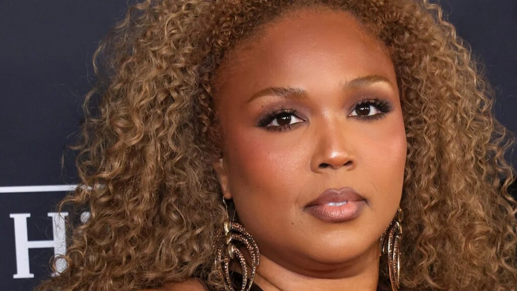 Lizzo Braless In Plunging Dress With Hip-High Slit Sparks Thirst