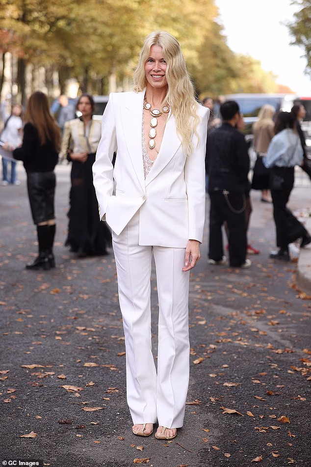 Claudia Schiffer, 56, turns heads in a plunging blazer as she brings some supermodel glamour to Chloe’s Paris Fashion Week show